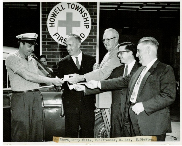 Ed Myers on left accepting keys to new ambulance